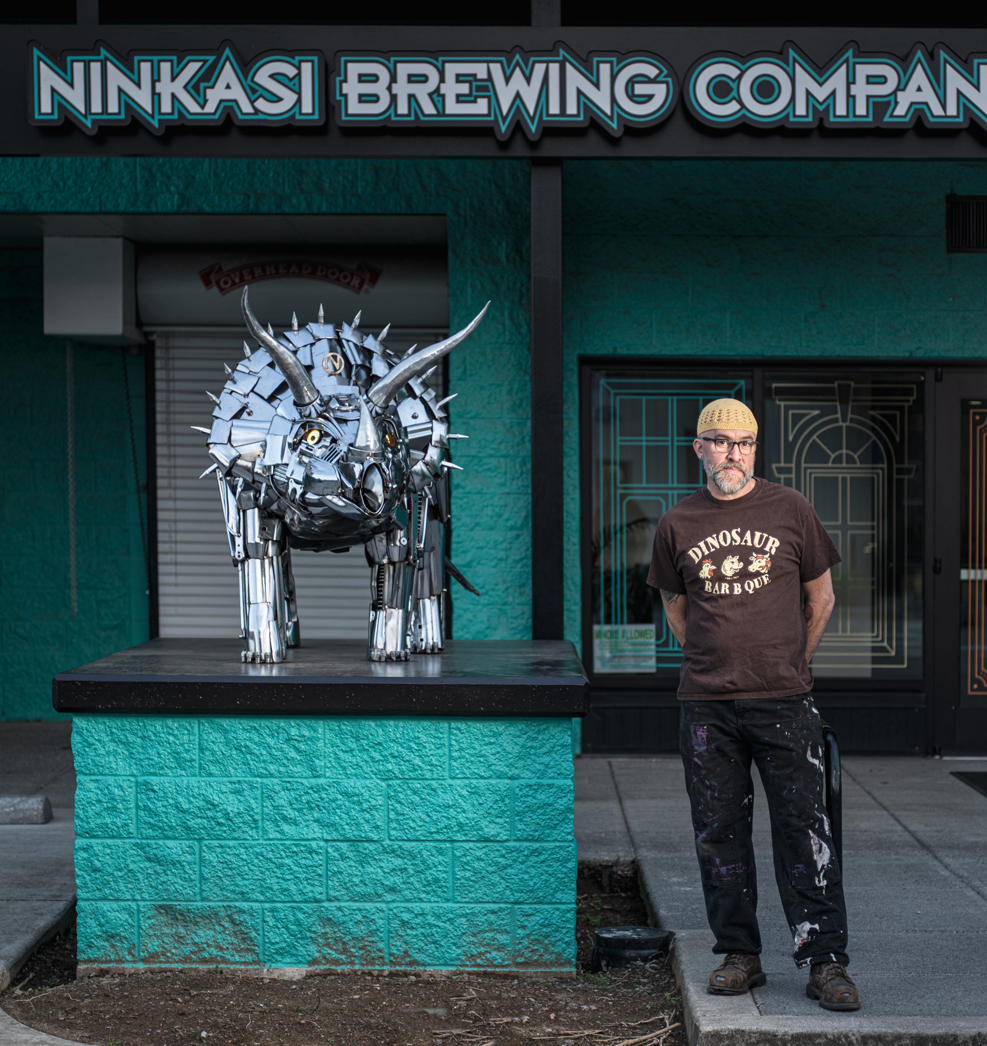 Jud with the Tricerahops sculpture at Ninkasi HQ in Eugene, OR